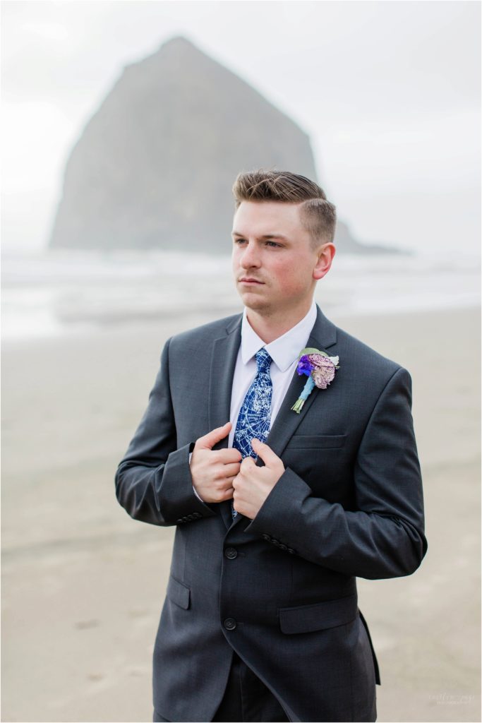 Groom standing on Cannon Beach
