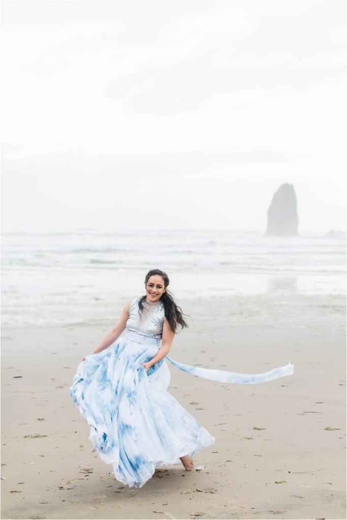 Bride dancing on Cannon Beach in tie dyed skirt