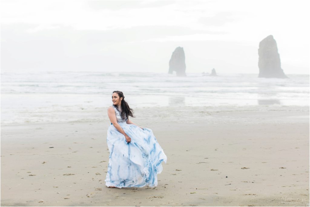 Bride dancing on Cannon Beach in tie dyed skirt