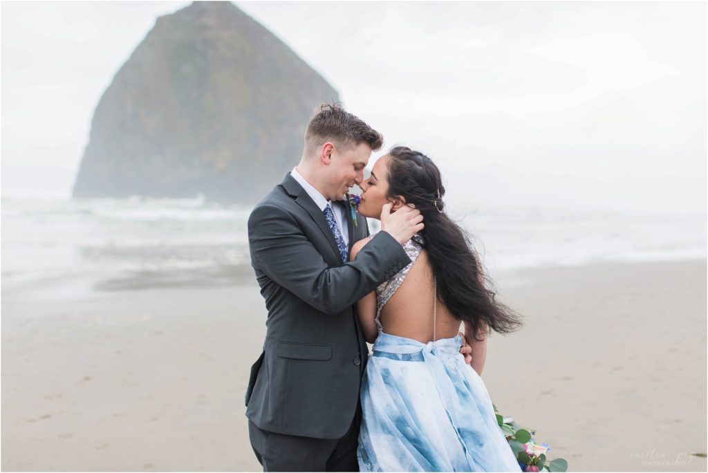 Bride and groom standing forehead to forehead on Cannon Beach Oregon