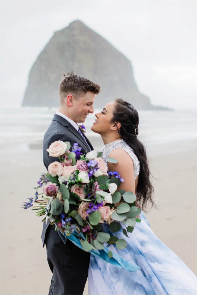 Couple standing together on Cannon Beach after eloping