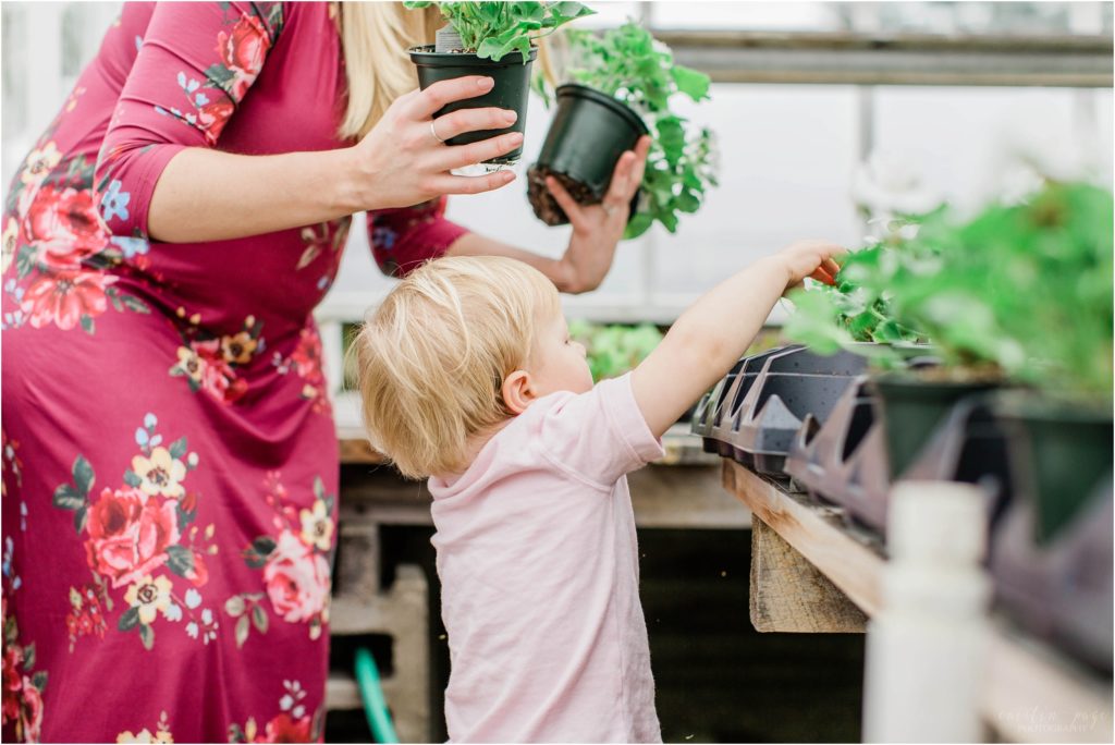 little boy pointing at plants