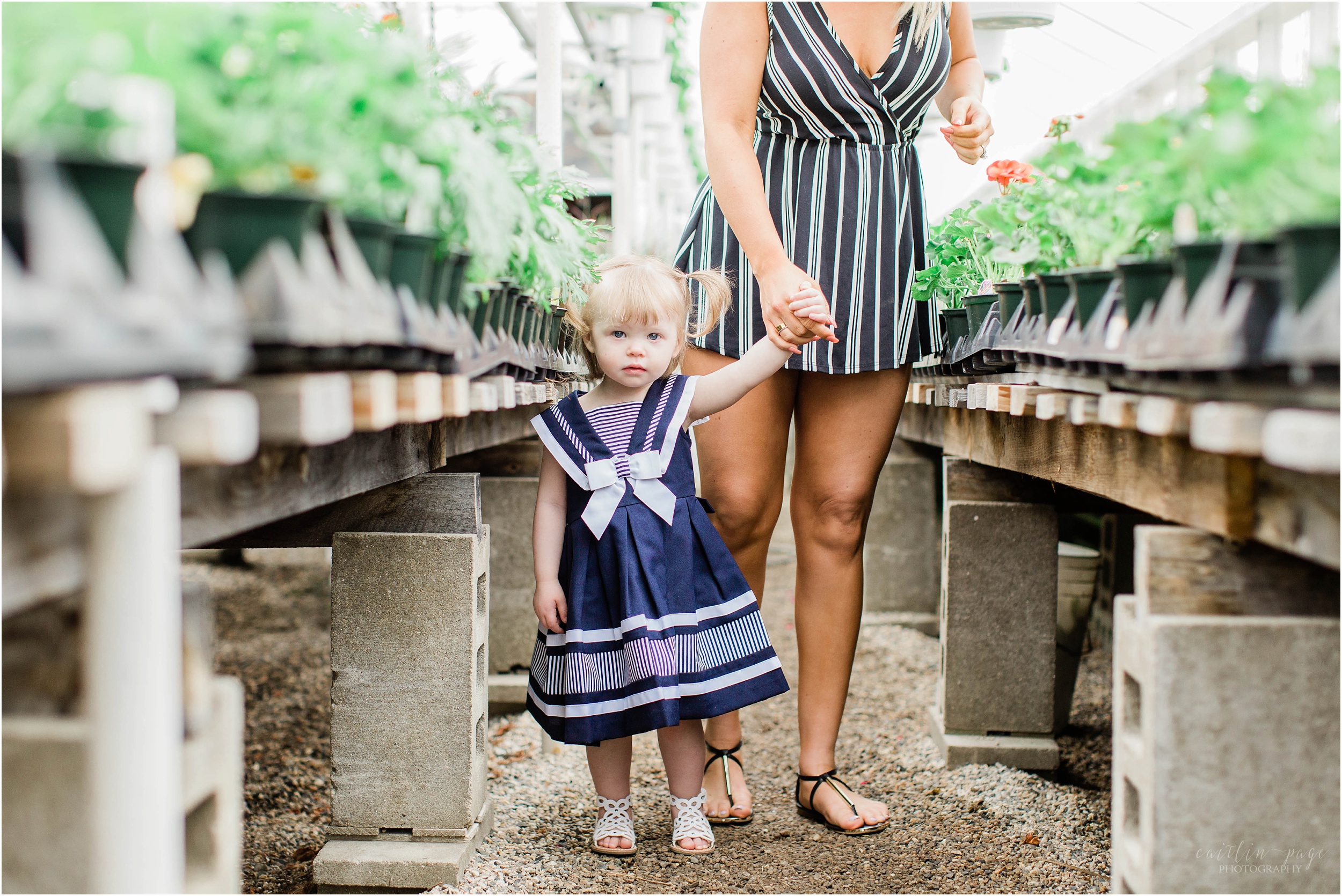 little girl standing in nursery aisle