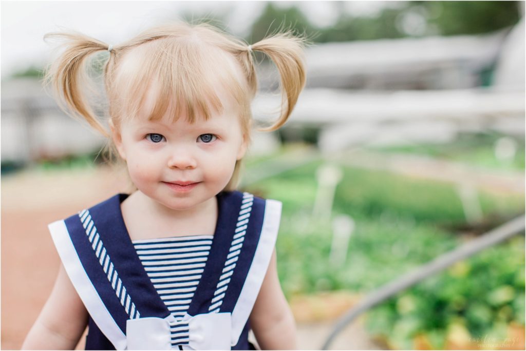 little girl with pigtails and striped dress