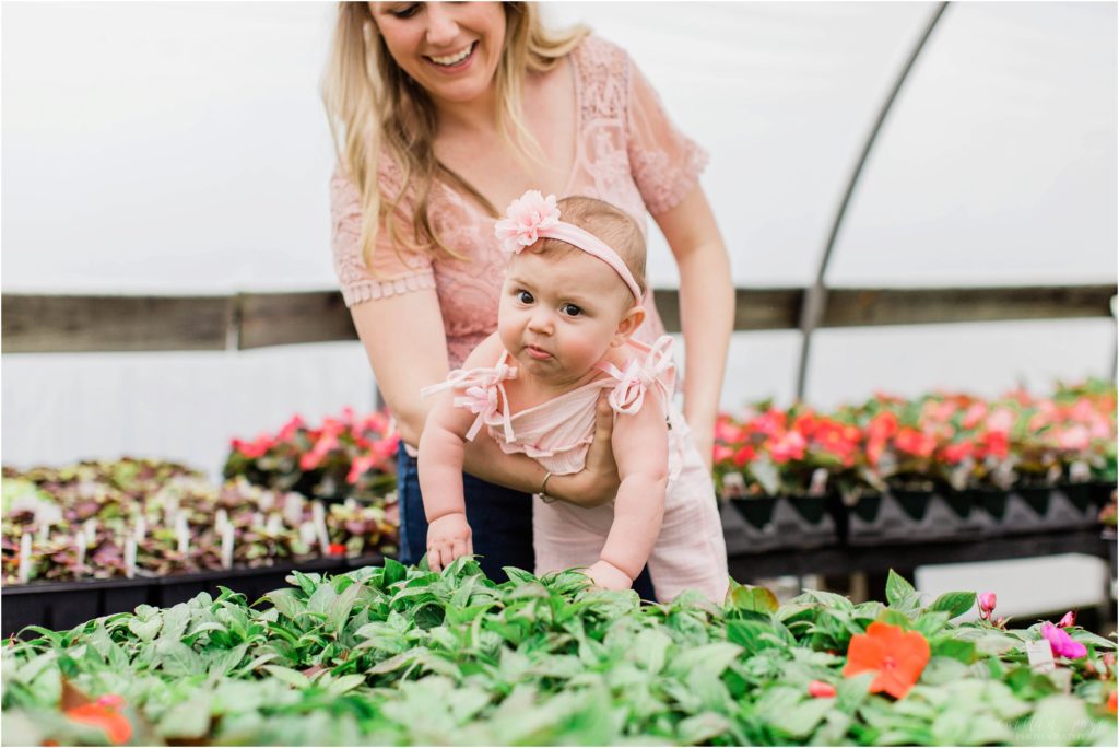 baby girl touching plants