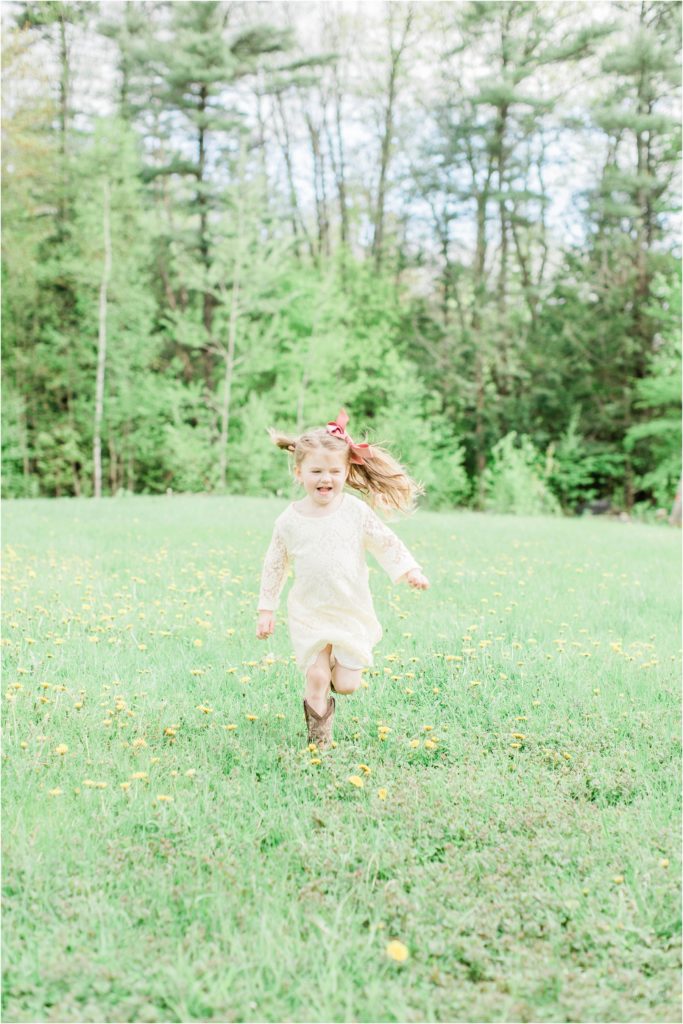 little girl running through field