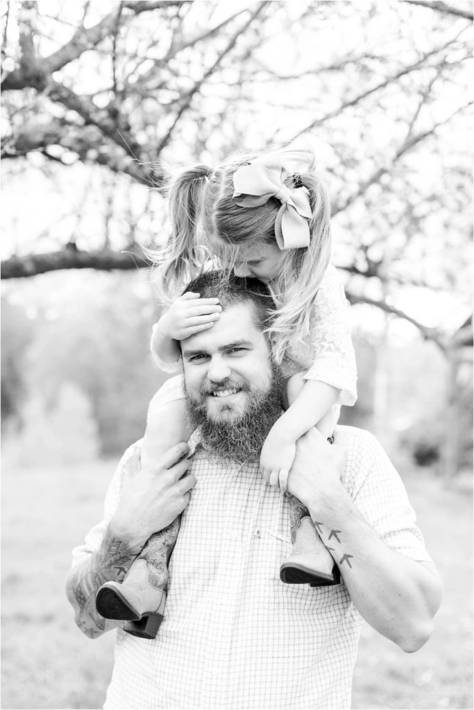 little girl kissing dad on head