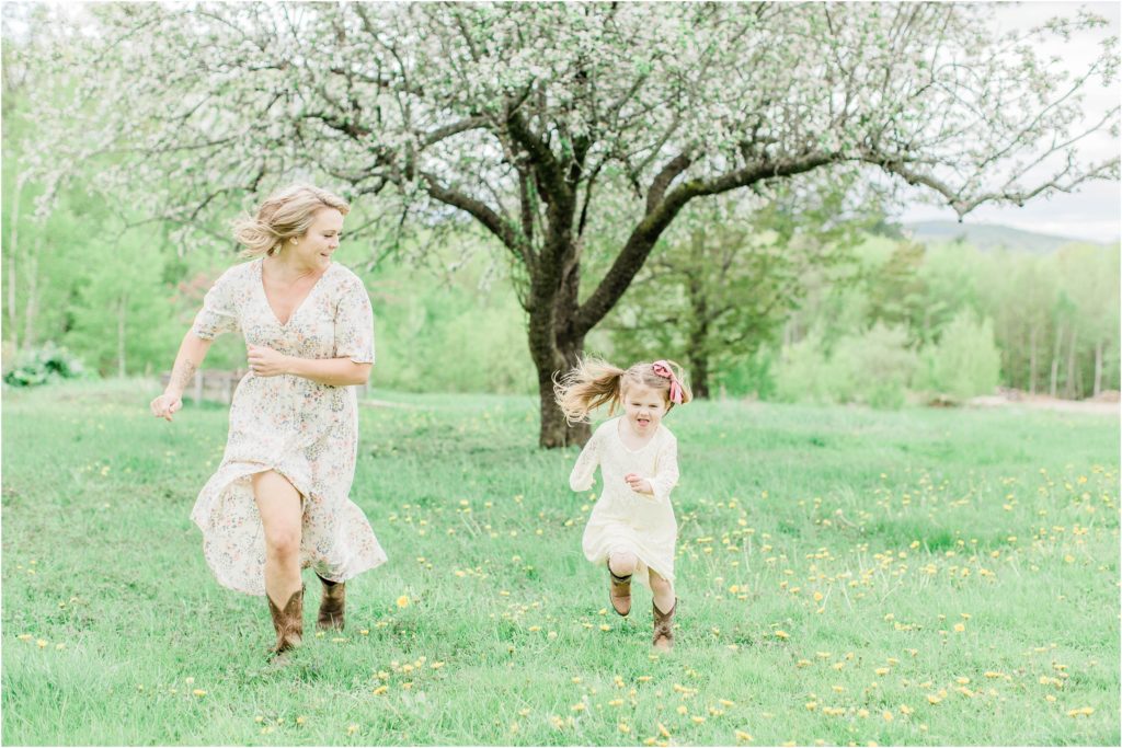 mom and little girl running through field
