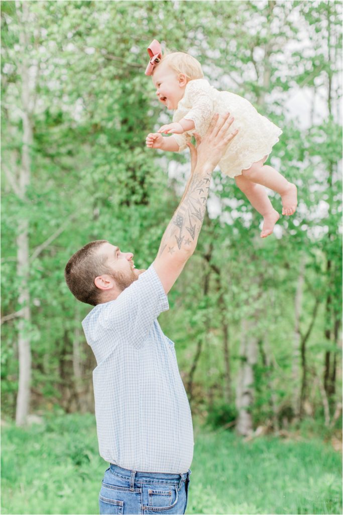 dad throwing baby in air