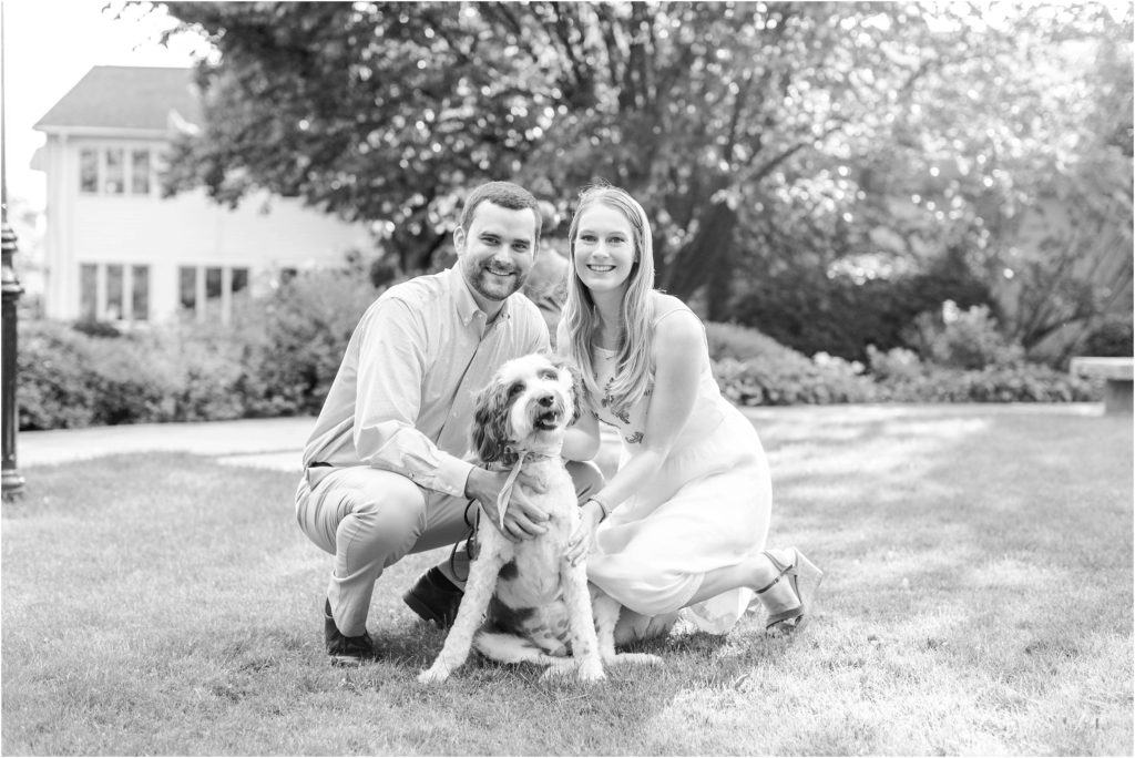 black and white photo of couple with puppy