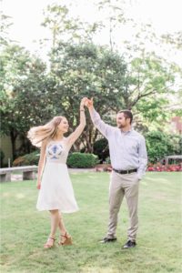 Man twirling woman in white dress at Cate Park