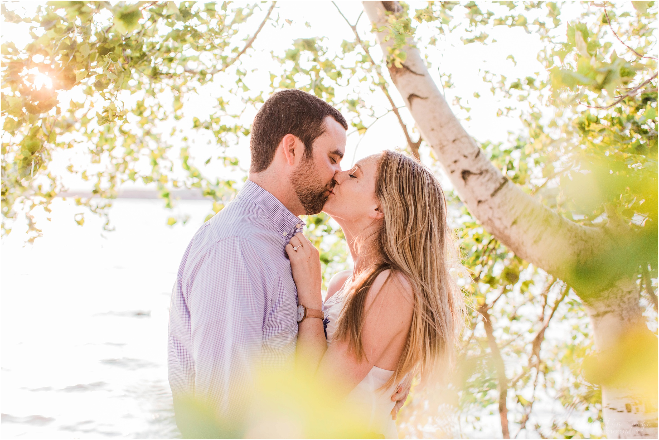 man and woman kissing at sunset