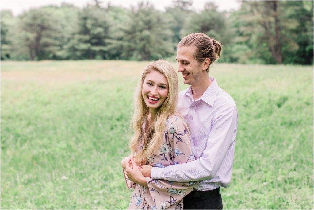 Man holding laughing woman in a field