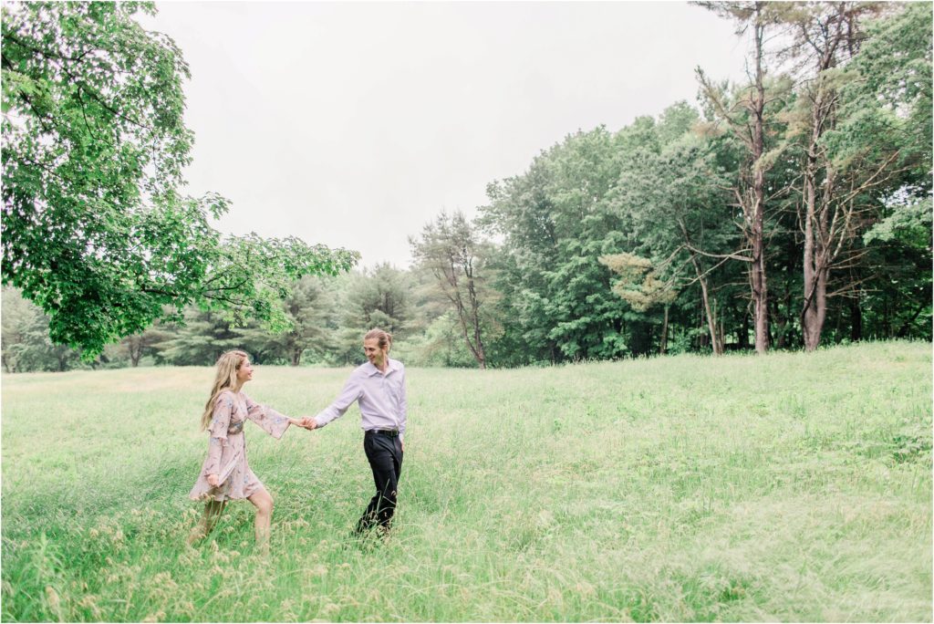 Man and woman walking through field togehter