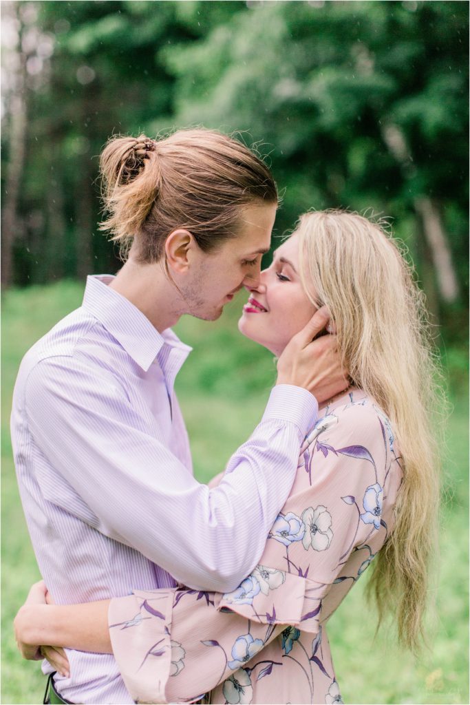 Man holding woman's face in field