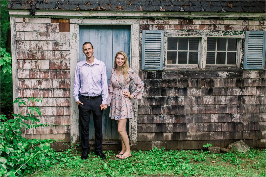 Man and woman standing in front of old shed together