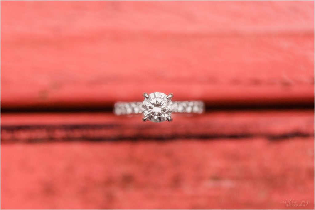 Engagement ring on top of red table