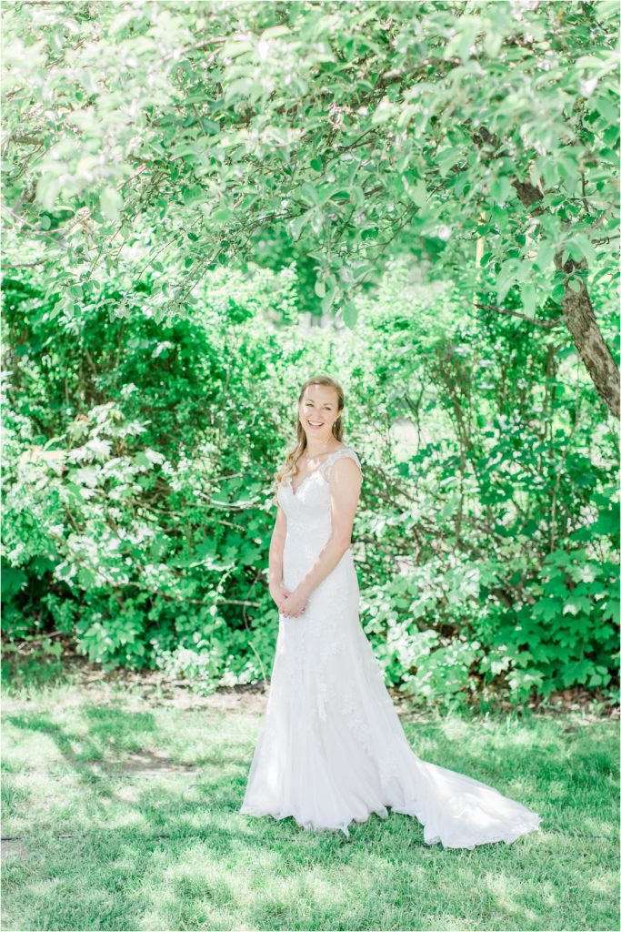bride standing under trees