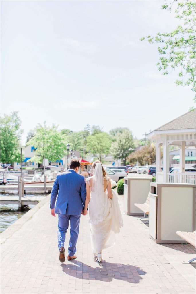 bride and groom walking by docks