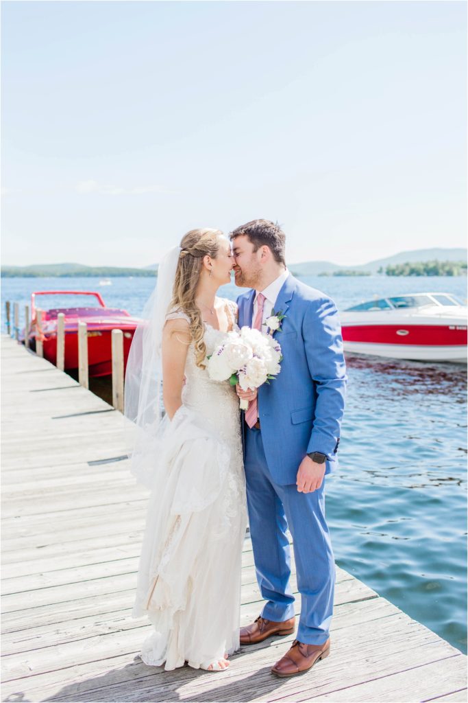 bride and groom kissing on town dock