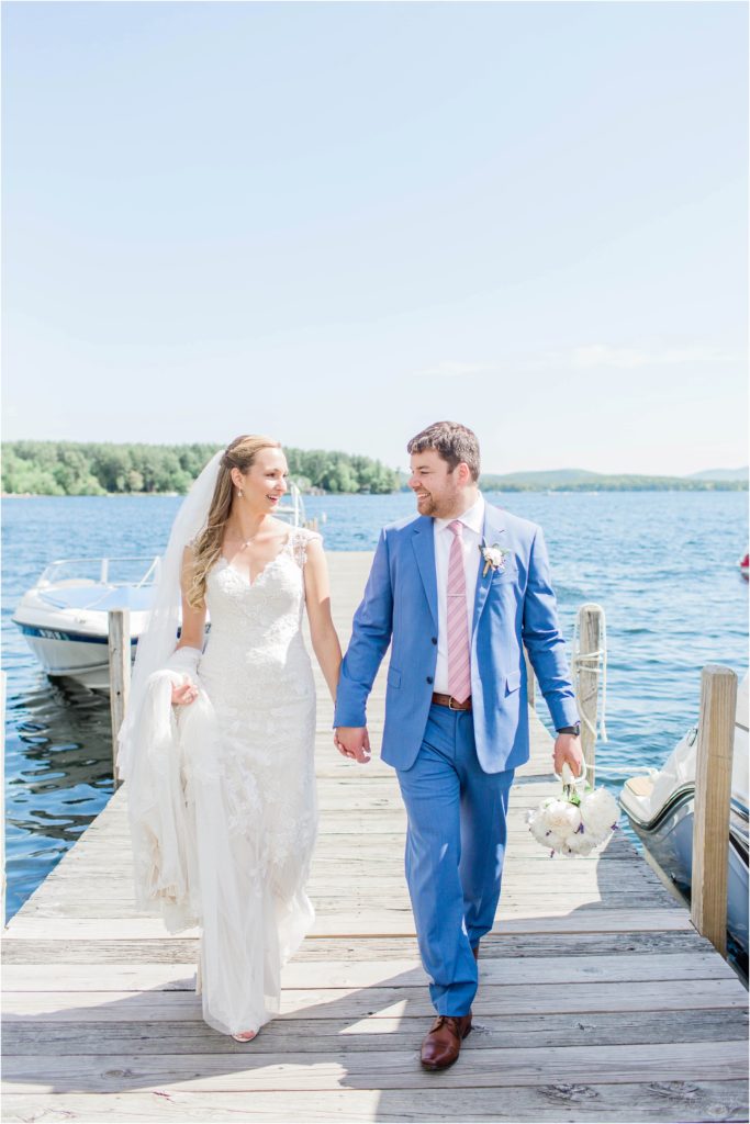 bride and groom walking down town dock