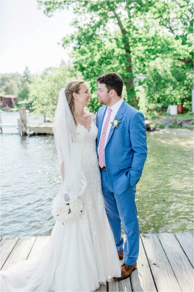 bride and groom standing together on dock