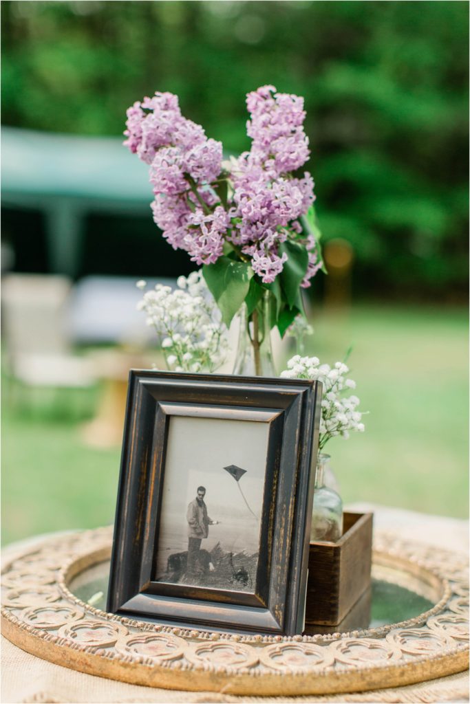 photo of man in front of lilacs