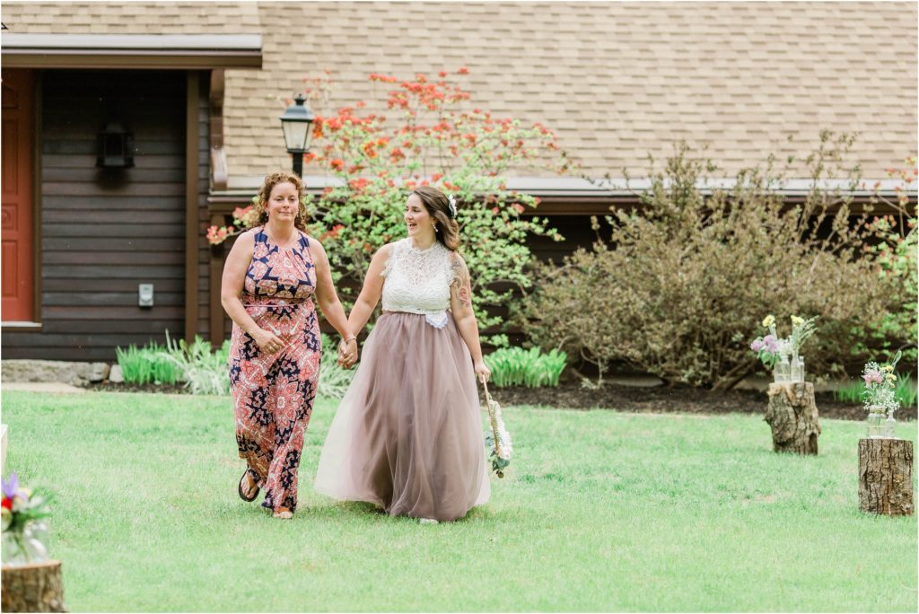 bride and her mom walking down the aisle together