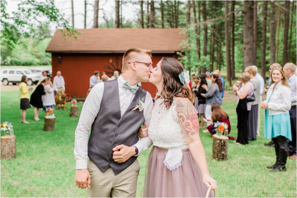 bride and groom kissing during recessional