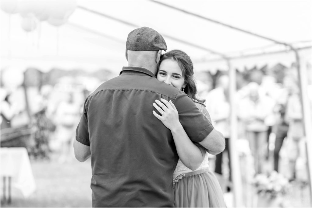 black and white shot of bride dancing with her dad