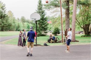 guests playing basketball at wedding reception