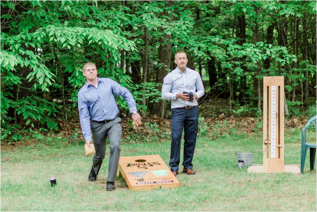 guests playing corn hole at wedding reception