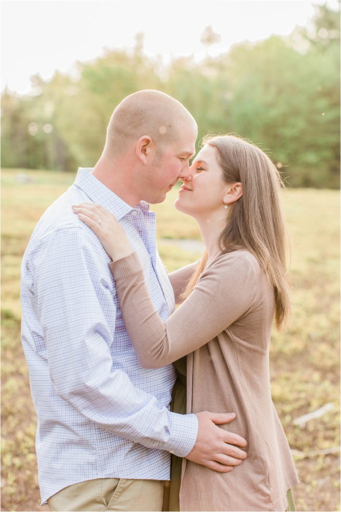 couple almost kissing in field