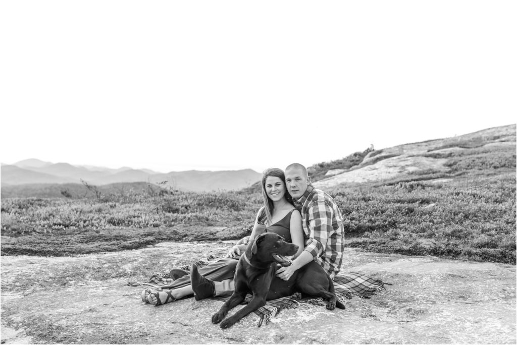 black and white portrait of couple sitting with dog