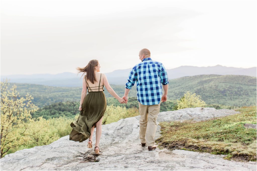 man and woman walking towards top of mountain