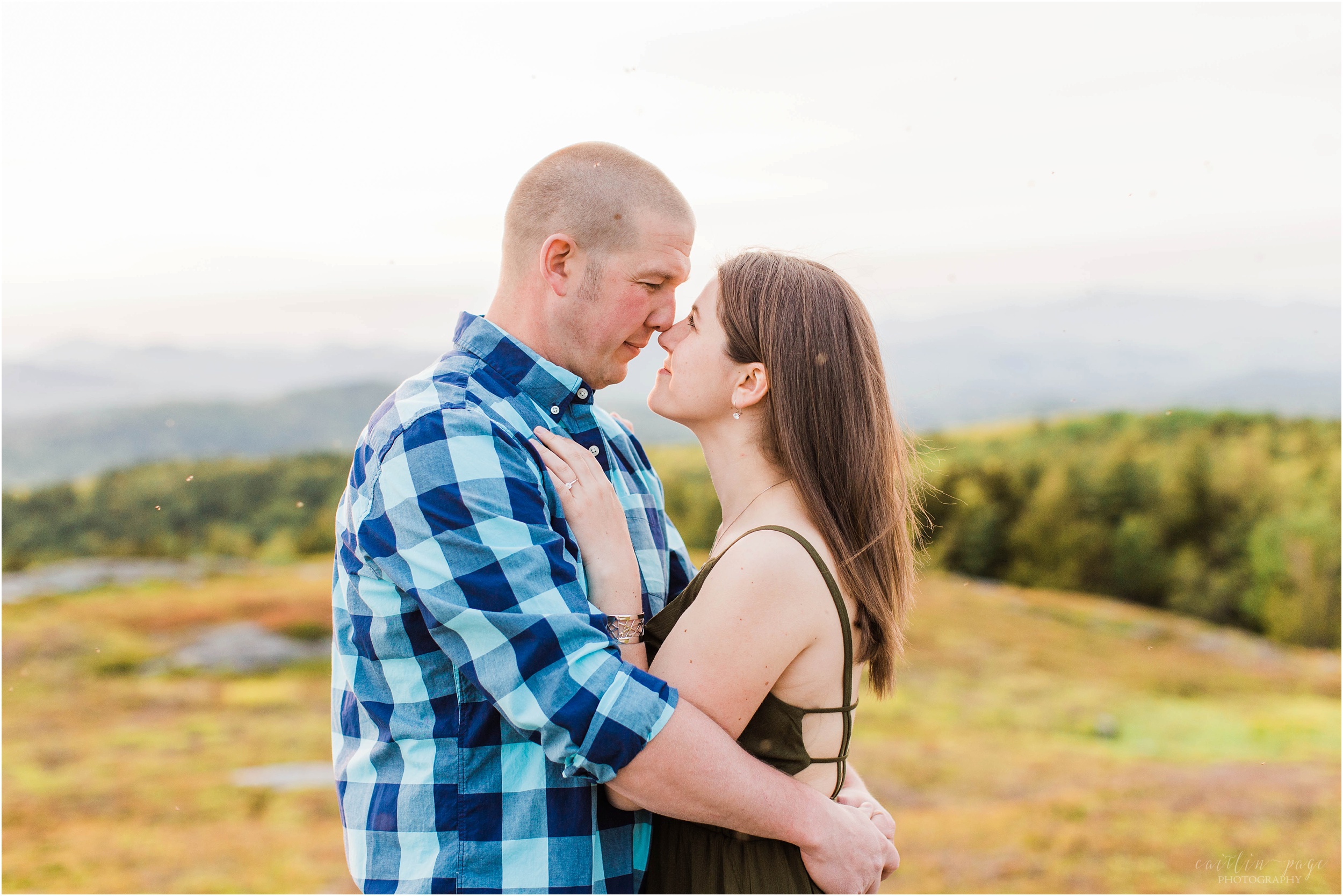 couple nuzzling together at sunset