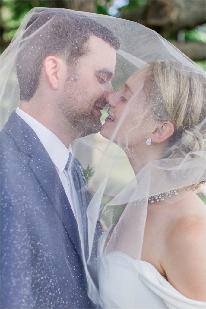 Bride and groom portrait at Cate Park Wolfeboro with glitter veil