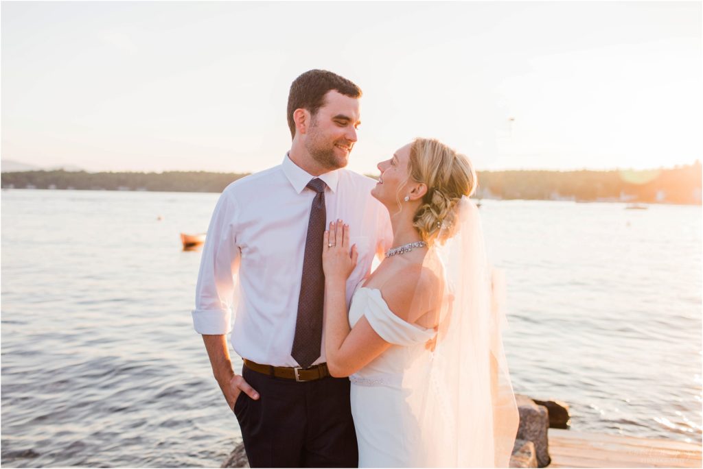 Sunset portraits of bride and groom on dock at Brewster Boathouse Wolfeboro New Hampshire