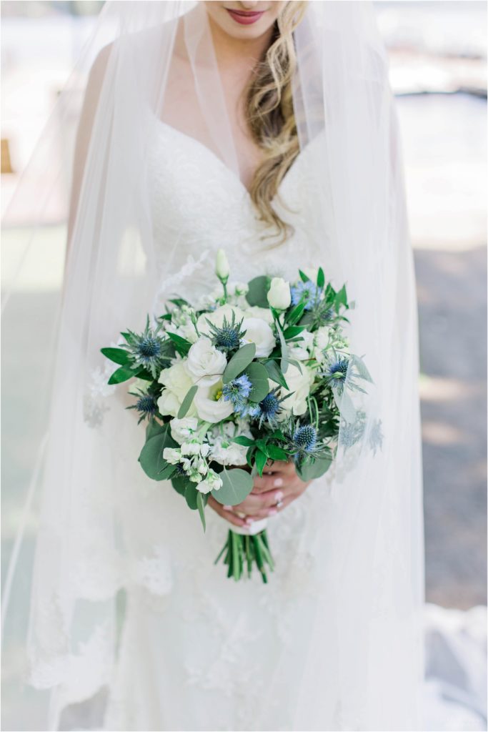 wedding bouquet with white roses and blue thistle