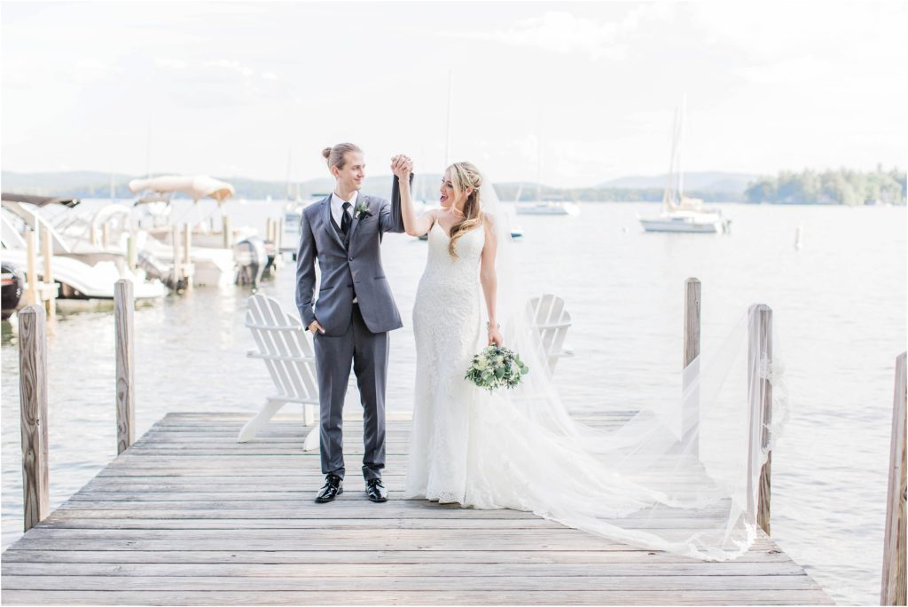 bride and groom cheering on dock