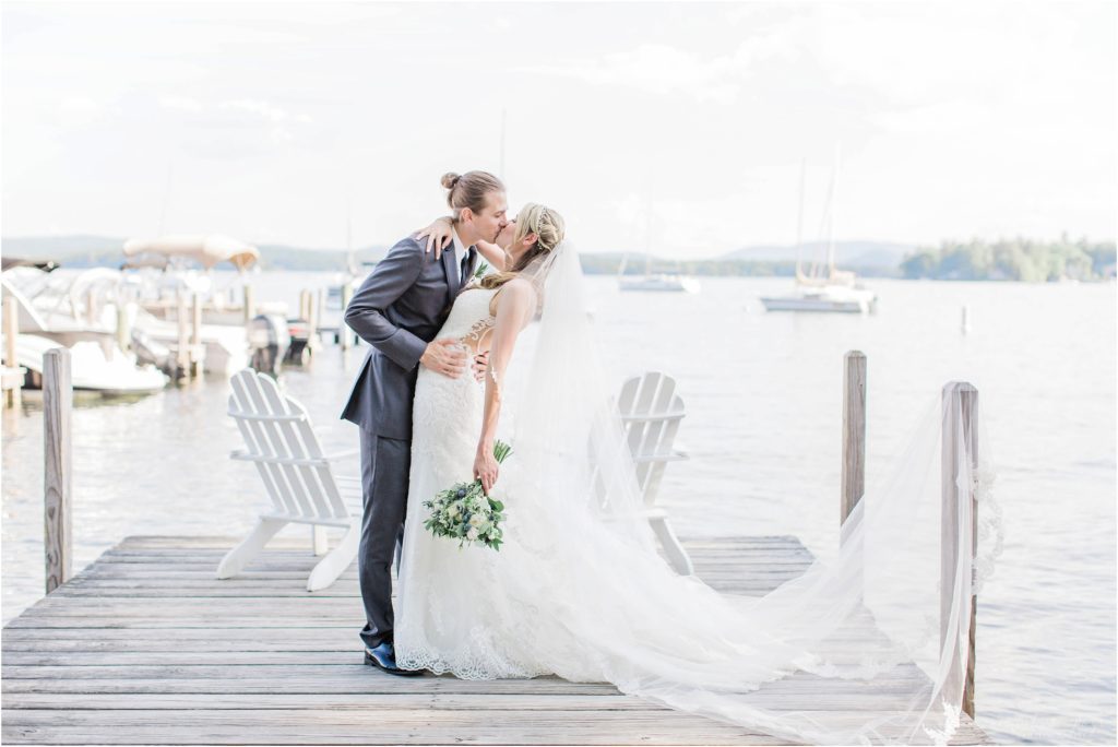 groom dipping bride in kiss on dock