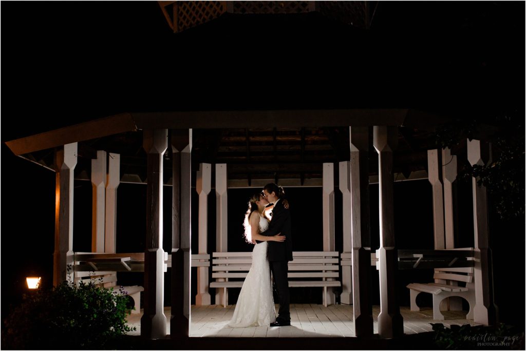 night portrait of the bride and groom in a gazebo