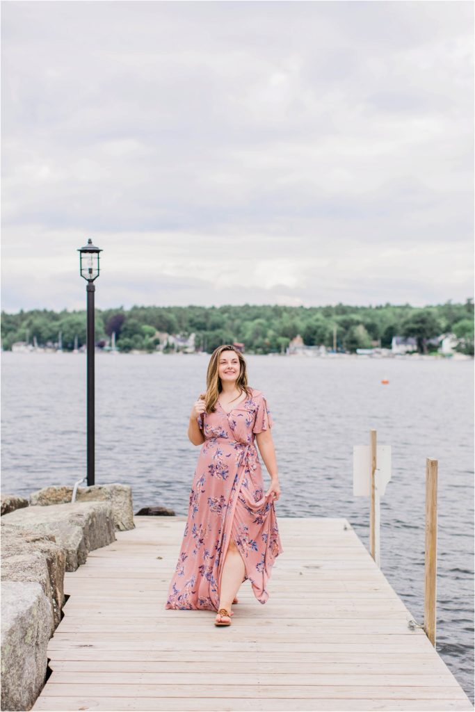 Senior girl walking down dock in Wolfeboro