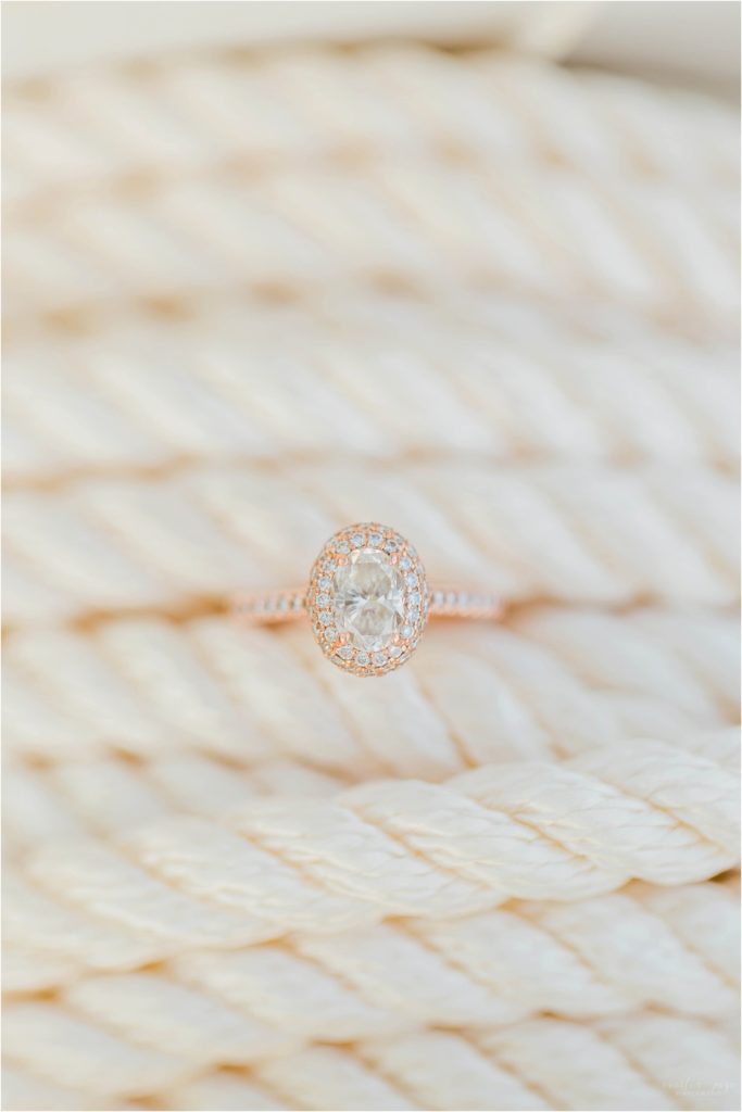 Rose gold engagement ring with oval diamond and halo