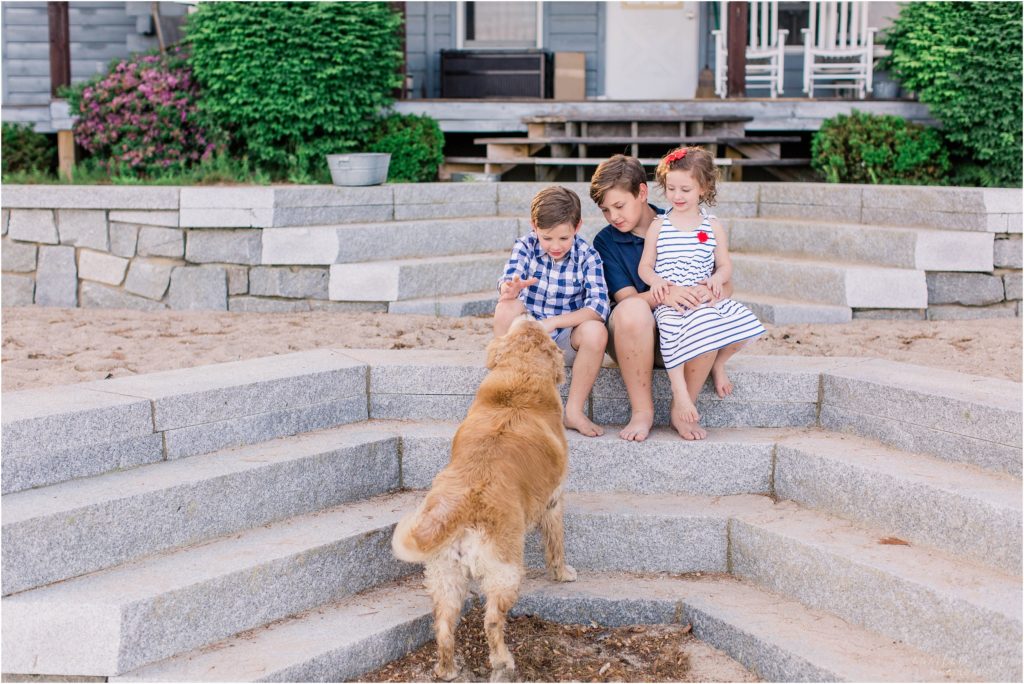 Kids playing with dog sitting on steps
