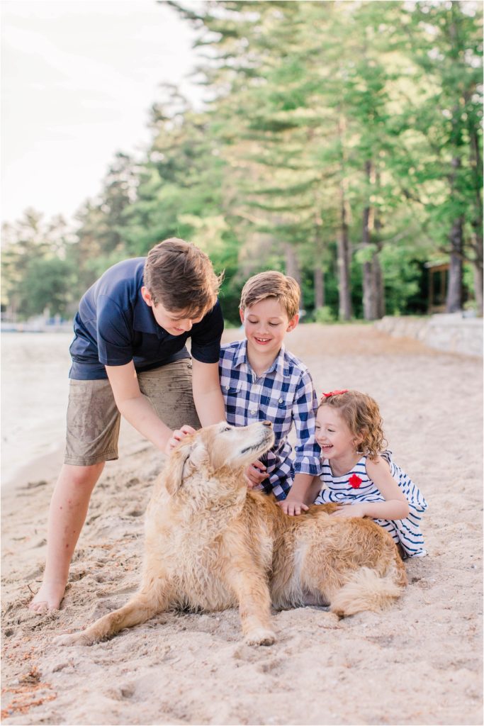 Kids playing with dog on beach