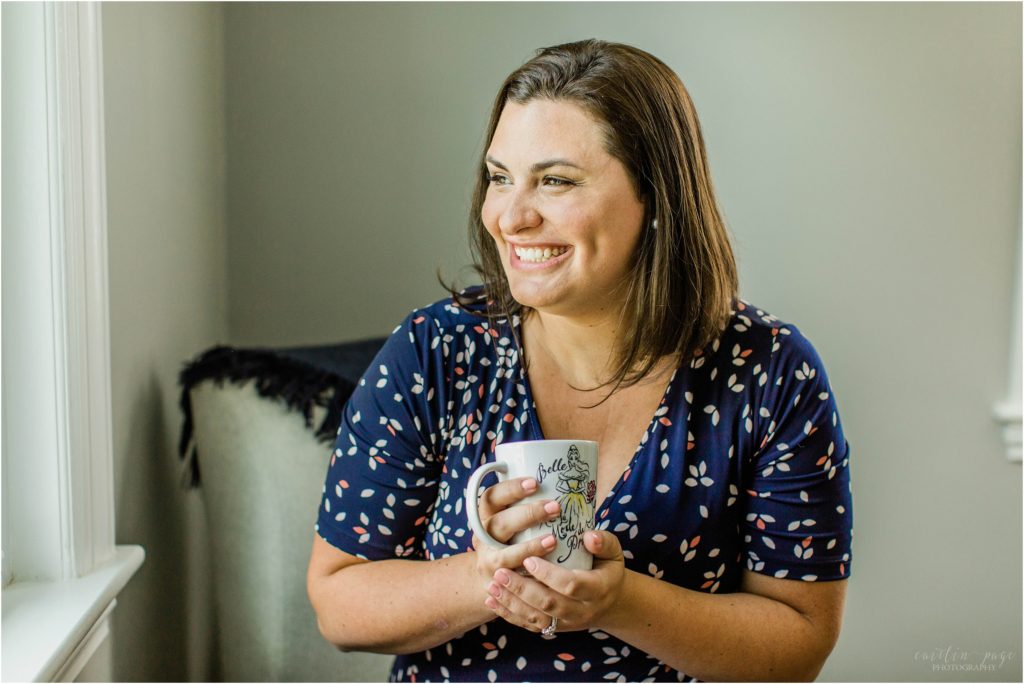 Woman holding onto Disney mug