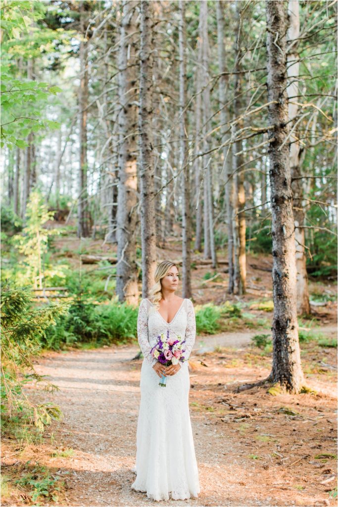 Bride standing in middle of trees