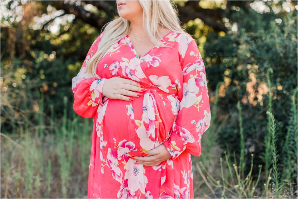 Pregnant belly in pink flowered dress