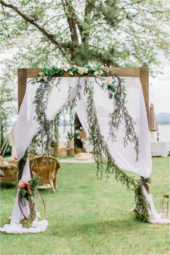 Arched entryway with draped linen and garlands summer bridal shower inspiration